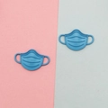 Macro detail of blue matte mask-shaped alloy charms for DIY jewelry and accessories - Blue