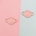 Detailed macro view of pink matte resin face mask charms for DIY jewelry and accessories - Pink