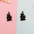 Detailed close-up of two black and orange Halloween haunted house alloy charms - Black