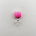 Macro detail of miniature bubble tea glass with pink liquid and tiny black pearls - Rose Red