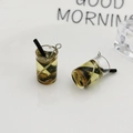 Macro shot of mini resin yellow bubble tea pendant with black straw and gold glitter detail - Gold