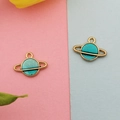 Detailed close-up of gold-plated Saturn charms with blue enamel for DIY jewelry making - Green Celestial Planet