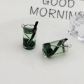 Macro detail of miniature resin green tea charms with silver eyelet hooks for DIY crafts - Green