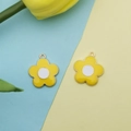 Detail showing two plumeria flower pendants in gold-plated alloy for DIY jewelry - Yellow