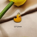Detailed macro view of a 12x12mm yellow enamel duck pendant with golden metal edges - 12x12mm / Yellow Duck