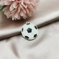 Detail of a black and white football pendant in gold finish on champagne satin - Football Shape / Football