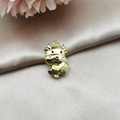 Macro shot of a golden alloy cartoon ox charm with fortune symbols for DIY jewelry - K Gold Pink Fortune Ox