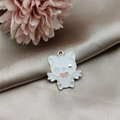 Detailed view of white cartoon cat alloy charm with pink bow for DIY jewelry making - Cat