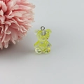 Macro view of a yellow translucent resin gummy bear pendant with shiny inner gold glitters - Yellow