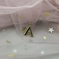 Detail of gold letter A pendant with black enamel finish and round hanging loop for DIY jewelry - Letter A