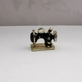Macro shot of retro sewing machine pendant with black enamel finish and shiny rhinestones - Black