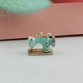 Macro detail of sewing machine charm with mint green enamel and sparkling white rhinestones - Blue