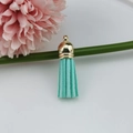 Detailed view of mint green suede tassel with gold metal cap for DIY jewelry - Pale Green