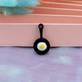 Macro shot of miniature frying pan charm with resin fried egg detail for DIY jewelry - Black