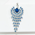 Elegant silver peacock brooch with ocean blue crystals and a teardrop main stone - Peacock Brooch / Silver Light Blue