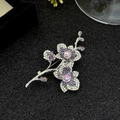 Elegant purple orchid brooch with cubic zirconia crystals on a black textured background - Purple