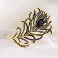 Peacock feather brooch in gold finish with rainbow rhinestones and purple gemstone - Colorful