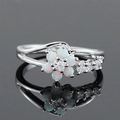 Elegant opal flower ring with zircon accents on a polished silver band with reflection - US 6 / White