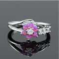 Close-up of pink opal flower ring with a center zircon on a reflective surface - US 7 / Pink