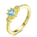 Macro shot of 18k gold plated ring with light blue center stone and beaded band details - Size 5 / Gold