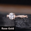Anello in oro rosa con zircone rotondo e fascia intrecciata su pietra scura - n.5 / Oro rosa