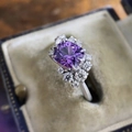 Elegant silver ring with a cushion-cut purple stone and white diamond halo in a velvet box - Cy1056 / Size 5