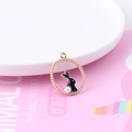 Cute black enamel rabbit charm with pearl detail in a gold dotted circular frame - Black