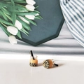 Close-up of miniature bubble tea resin charms with realistic black pearls and metal loops - Brown