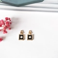 Detailed close-up of mini gold perfume bottle pendant charms with number 5 for DIY jewelry - Black