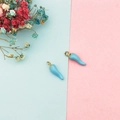 Macro detail of sky blue chili charms for DIY jewelry making with gold-plated loops - Blue