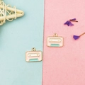 Macro shot of retro cassette alloy pendants in pink and blue for DIY jewelry making - Retro Cassette Tape Recorder
