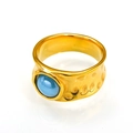 Macro detail of hammered gold stainless steel ring featuring a round blue natural stone - Gold Light Blue Ceramic