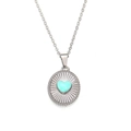 Detail of 18K gold necklace with heart turquoise stone and sunburst metal texture - Steel Blue Enamel