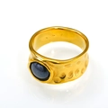 Macro detail of vintage gold-plated wide ring with hammered texture and oval blue stone - Gold Black Ceramic