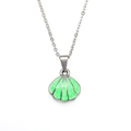 Detailed close-up of shell pendant necklace with green enamel inlay and silver chain - Steel Green