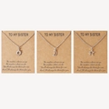 Detailed view of sun moon and star pendant necklaces on To My Sister gift cards - Sister Card Style (N00064)