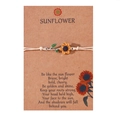 Close-up of woven sunflower bracelet with oil-drop pendant on an inspirational card - Beige Cord-Sunflower