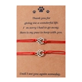Detail of red woven pet paw bracelets on brown memorial message display card - Red Line