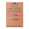 Close-up of pink braided pet memorial bracelets with silver paw heart charms on a card - Pink Thread