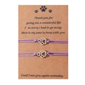 Detail of two-piece purple braided pet memorial bracelets with silver paw charms on card - Purple Cord