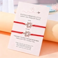 Pärchen-Armband-Set mit Stern-Anhänger und roter Kordel auf dekorativer Grußkarte - Sets / Silber/Rotes Seil