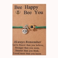 Detail of bee and sunflower charms on woven bracelet with an inspirational card - Green