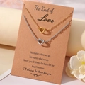 Gold and silver love knot necklaces on a rustic card with heartfelt English verse - Necklace And Card / Steel And Gold Love Theme