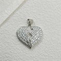 Macro shot of silver broken heart pendant with micro-paved sparkling zircon stones - Silver