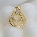 Macro shot of double ring pendant with zircon inlay and Greek key motif on white wave base - Gold