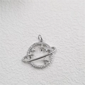 Detailed close-up of a planet-shaped silver pendant with stars and cubic zirconia inlay - Planet Pendant Silver