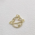 Detailed macro view of a gold-plated planet pendant with star ornaments and zircon stones - Planet Pendant Gold