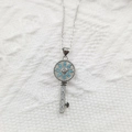 Macro shot of silver key pendant with turquoise flower and zircon details - Micro Pave Key Pendant Silver (Without Chain)