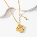 Minimalist gold necklace with vintage heart pendant and 520 engraving on white display - Hollow Clover Necklace