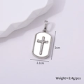 Macro shot of silver cross pendant showing dimensions 2cm by 1.1cm and 2.4g weight - Silver Style G